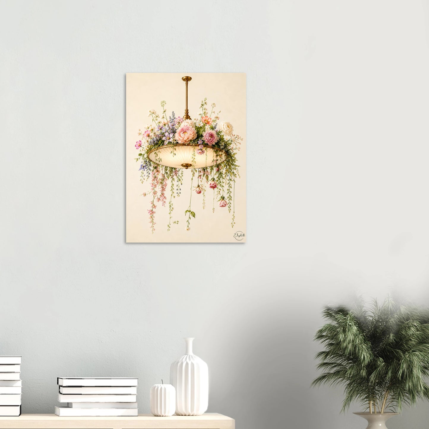 A vertical canvas art print featuring a vintage-style illustration of a hanging flower basket with pink and purple blossoms, displayed on a light gray wall above a styled shelf with books, white vases, and a potted plant.