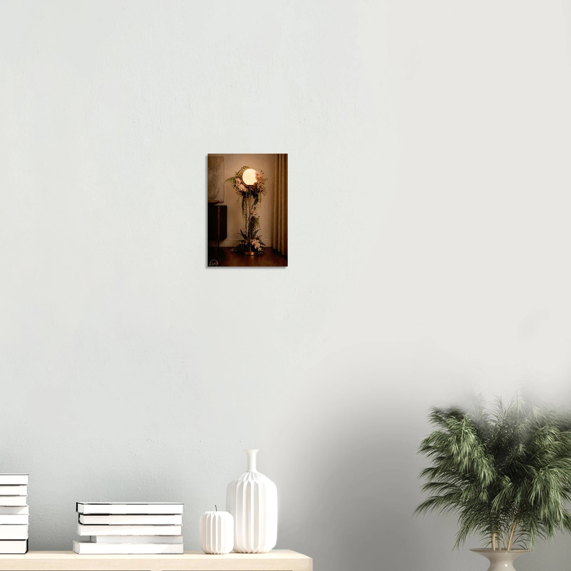 A vertical wall art print depicting a vintage-style floor lamp adorned with floral arrangements, displayed on a light gray wall above a console table with decorative vases and a potted plant.