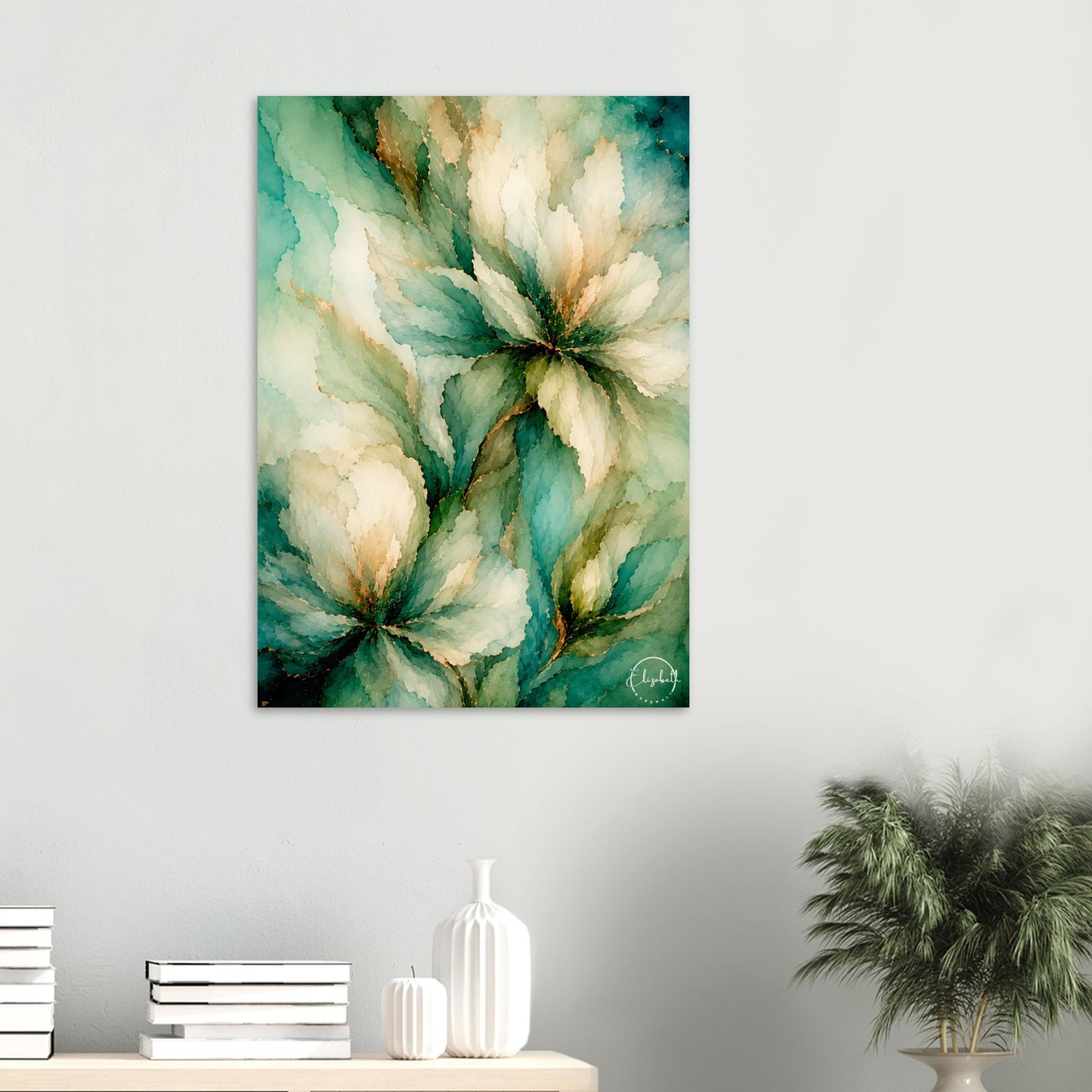 Abstract floral wall art print featuring large watercolor-style flowers in teal, green, cream, and gold tones, displayed on a light gray wall above a console table with books, a white vase, and a potted plant.