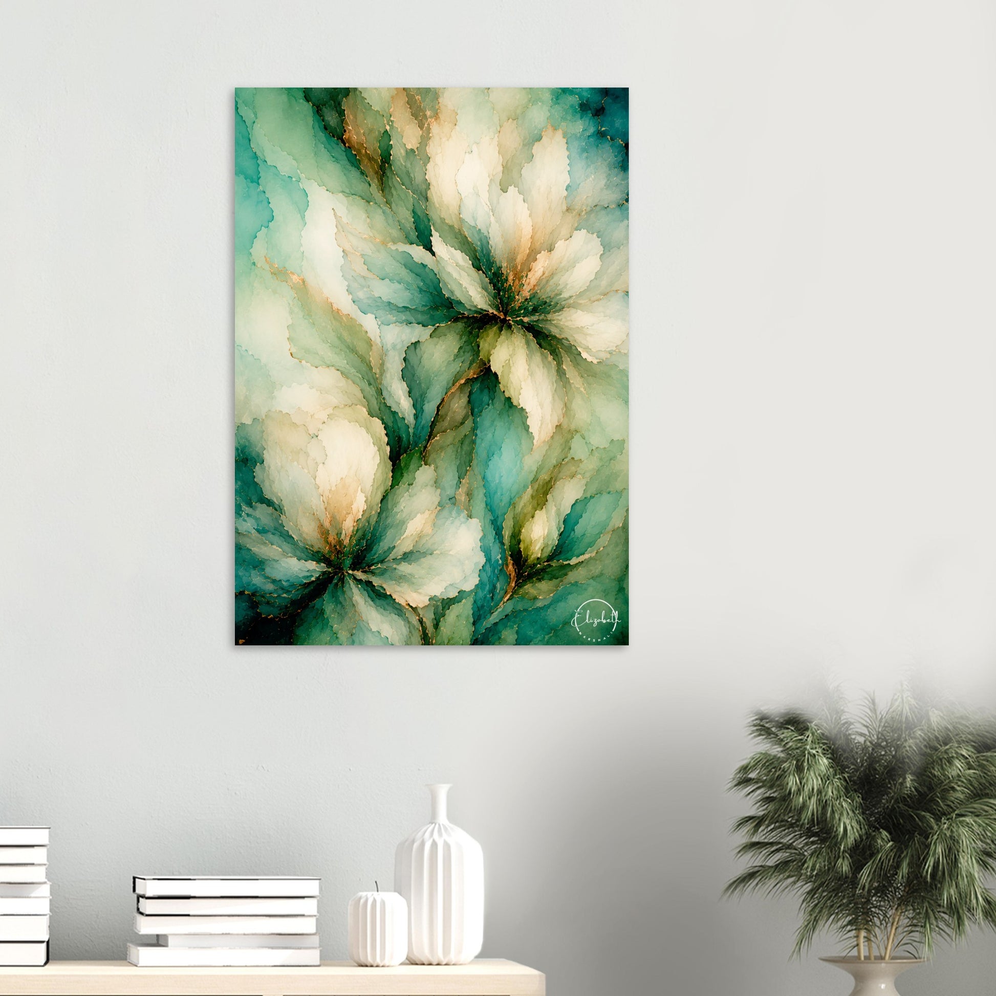 Abstract floral wall art print featuring large watercolor-style flowers in teal, green, cream, and gold tones, displayed on a light gray wall above a console table with books, a white vase, and a potted plant.