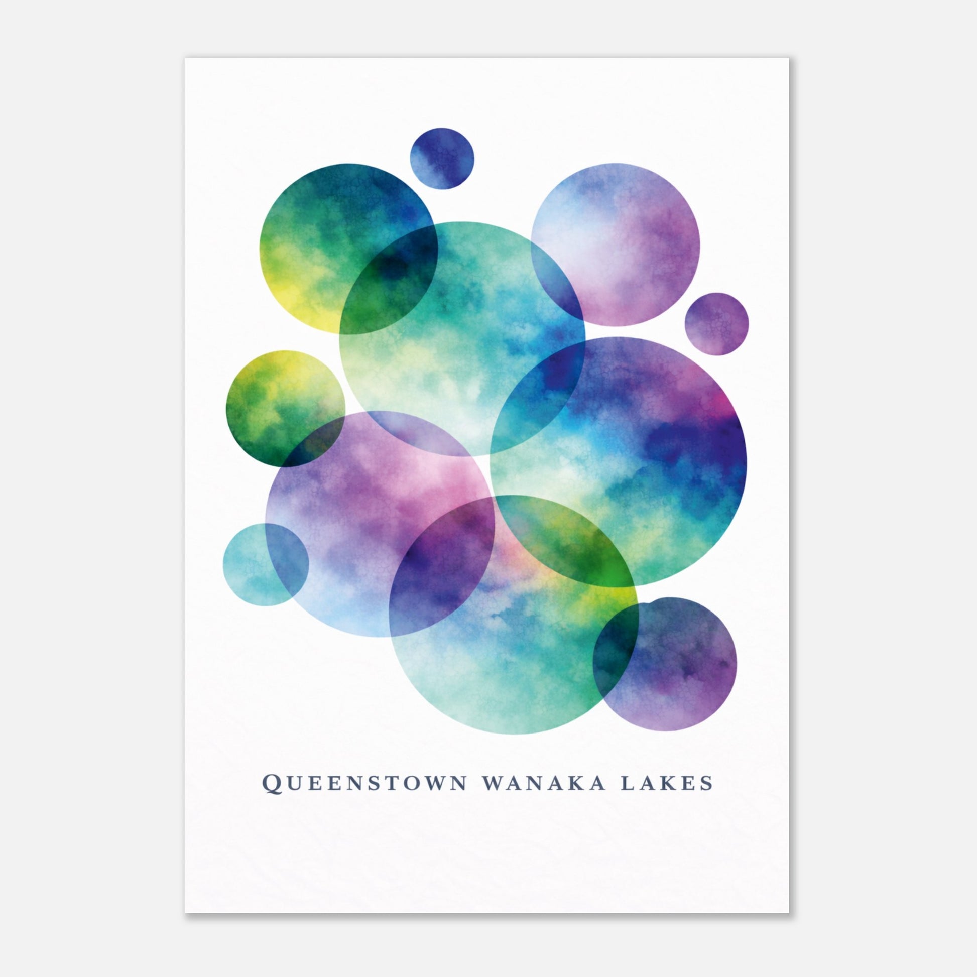 A vertical art print featuring overlapping translucent watercolor circles in teal, blue, purple, and green on a white background, with the text 'QUEENSTOWN WANAKA LAKES' printed below.
