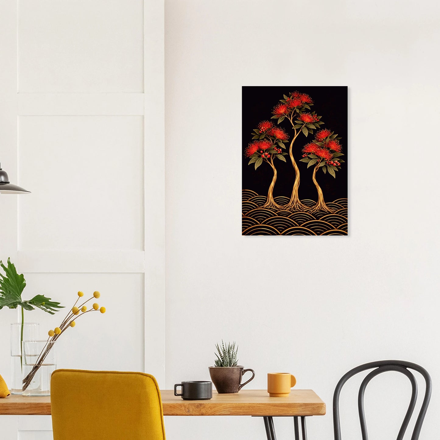 A vertical wall art print depicting three stylized red-flowered trees with gold trunks and wave-like gold patterns on a black background, displayed on a white wall above a dining table in a modern room setting.