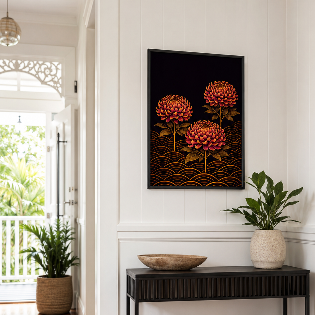A framed wall art print featuring three red-orange flowers on a dark background with gold wave patterns, displayed in a bright hallway above a black console table with plants and decor.