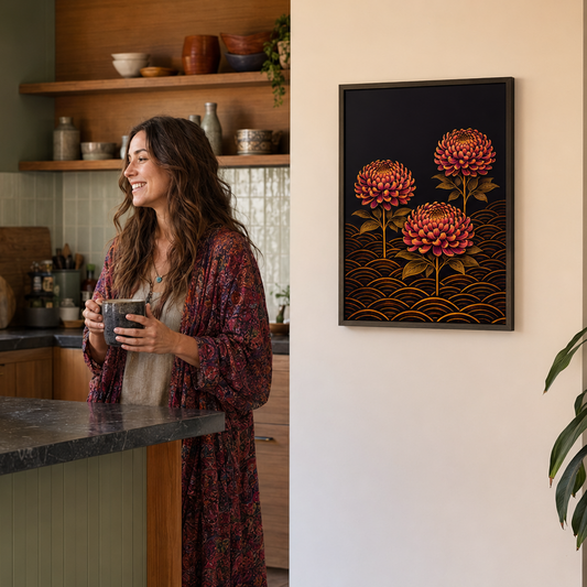 woman aughing in a warm, modern kitchen, with a framed art print featuring three pink flowers on a black background hanging on the wall to the right.