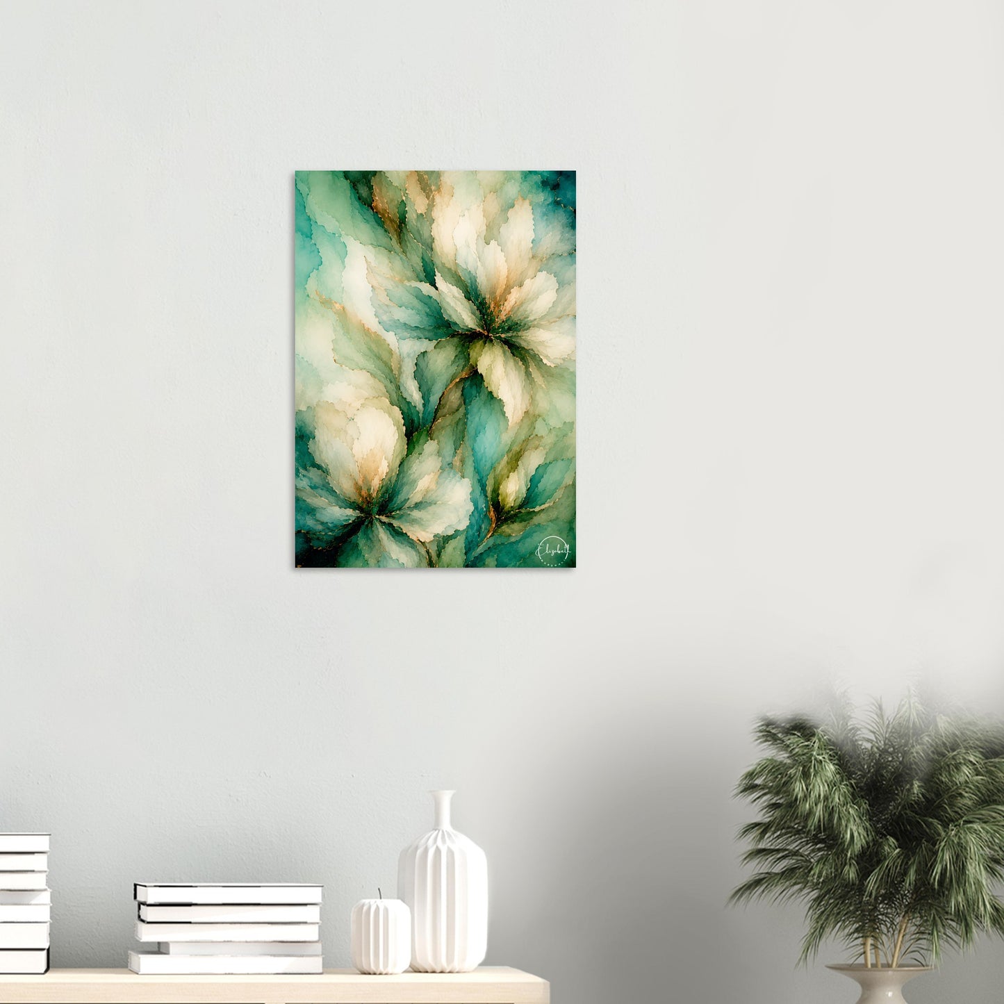 A vertical canvas wall art print featuring an abstract floral painting in teal, cream, and gold tones, displayed on a light gray wall above a console table with books and decorative vases.