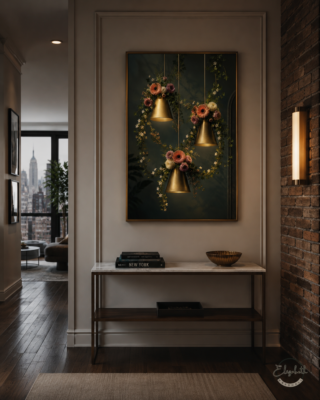 A framed wall art print depicting three hanging gold bell-shaped pendant lights surrounded by pink flowers and green foliage, displayed in a modern hallway above a console table.