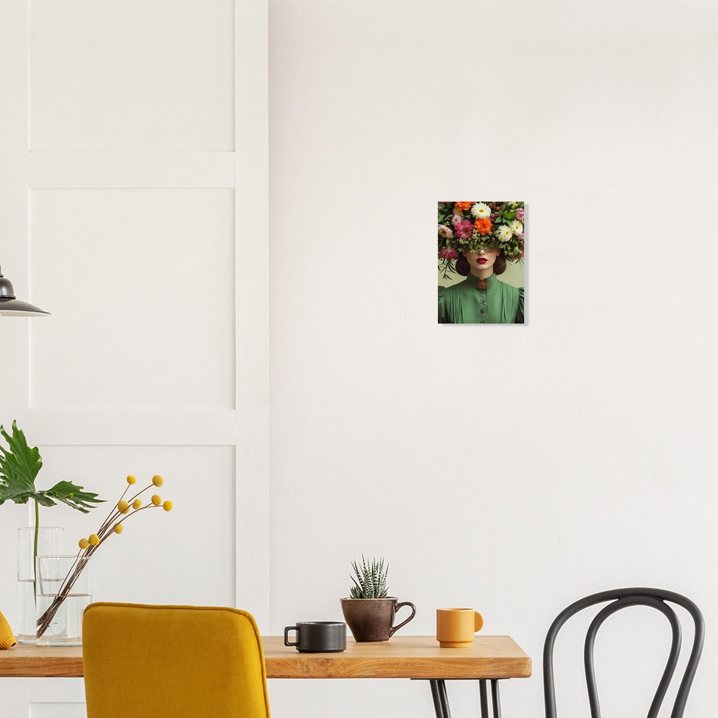 Modern interior with a wooden table, yellow chair, black chair, and framed artwork on the wall.