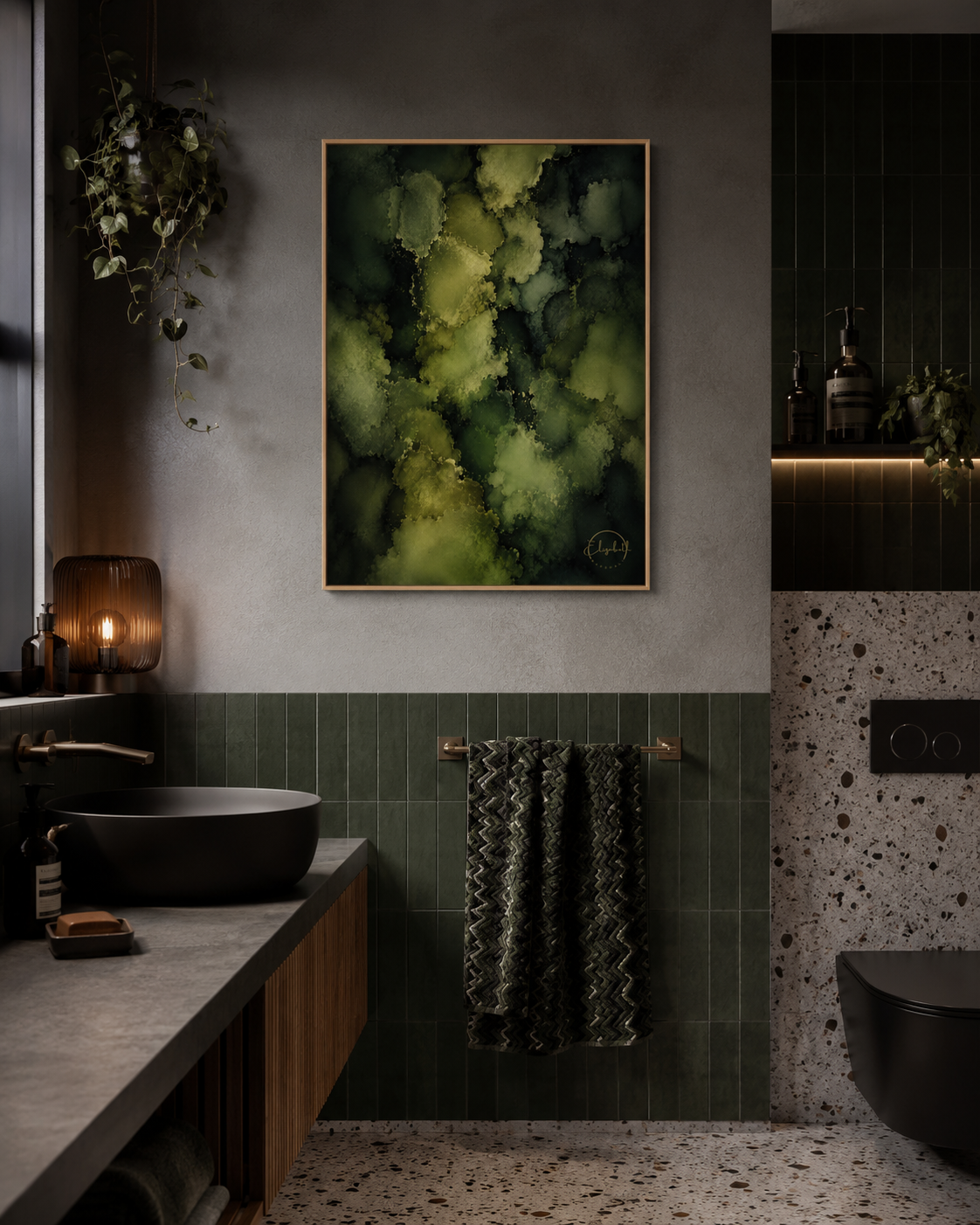 A framed abstract art print featuring textured green and yellow-green brushstrokes on a dark background, displayed on a gray wall in a modern, dark-toned bathroom setting.