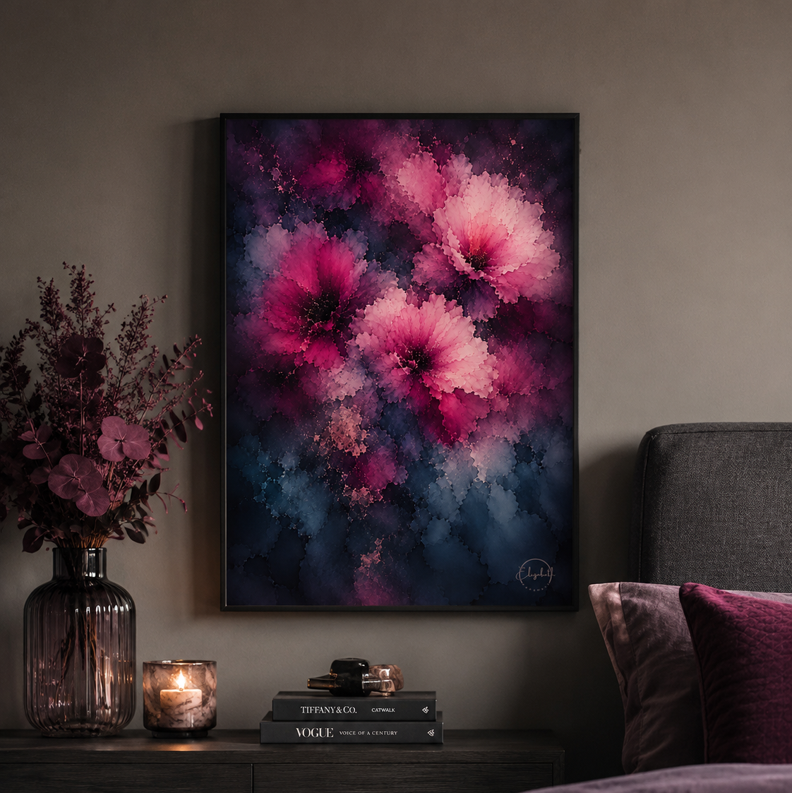 A framed abstract floral wall art print featuring vibrant pink and magenta flowers against a dark navy and purple background, styled in a bedroom setting above a dark wood nightstand.