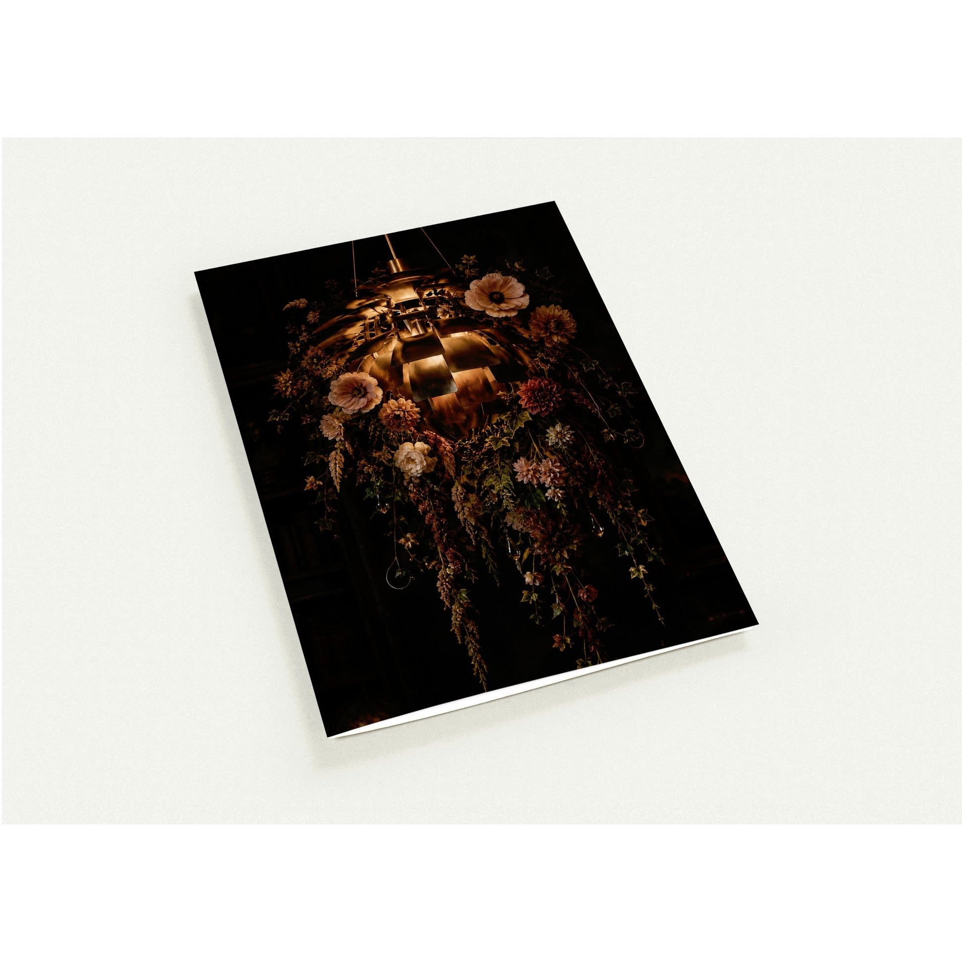 Cards with an atomic light and floral design on the cover against a white background