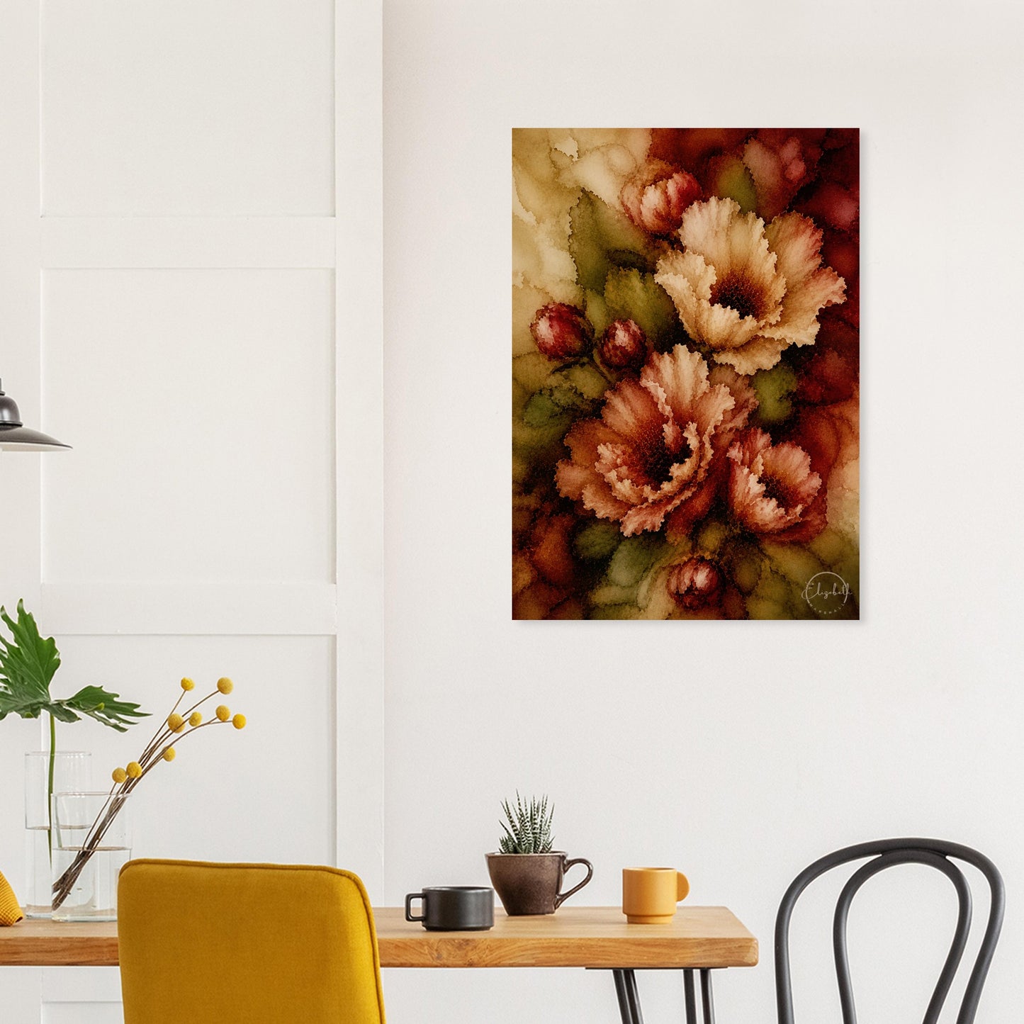 A vertical canvas wall art print featuring a close-up floral design in warm earthy tones, displayed on a white wall above a dining table with chairs and mugs.