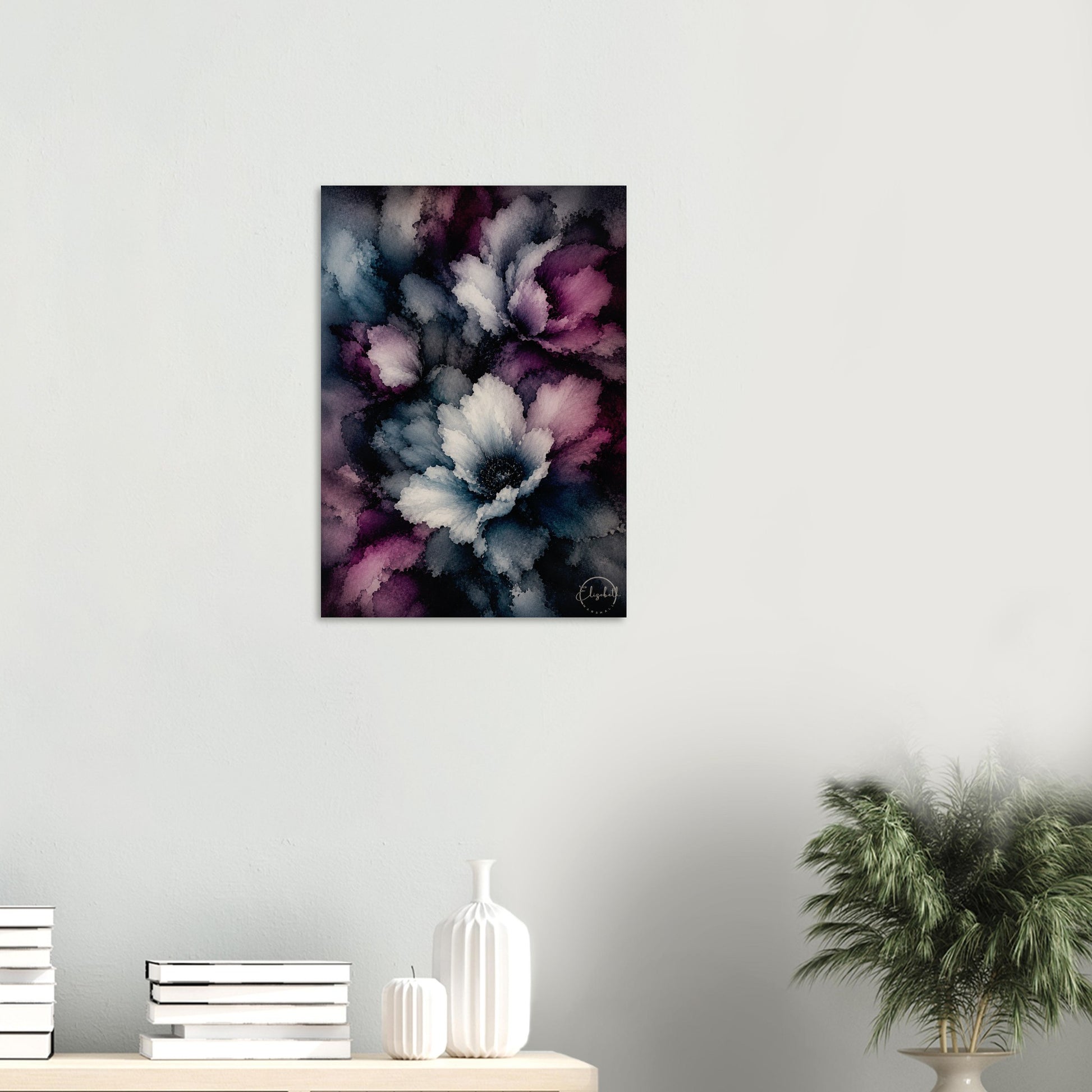 A vertical canvas wall art print featuring an abstract floral design in shades of purple, white, and blue, displayed on a light gray wall above a styled shelf with books, white vases, and a potted plant.