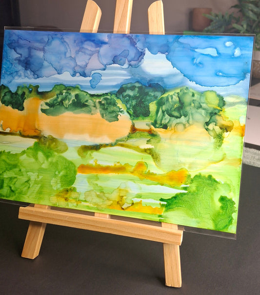 Original alcohol ink artwork on Yupo paper. Rolling Otago paddocks in amber, gold and forest green beneath a cobalt sky. A4, unframed. Free post NZ & Australia.