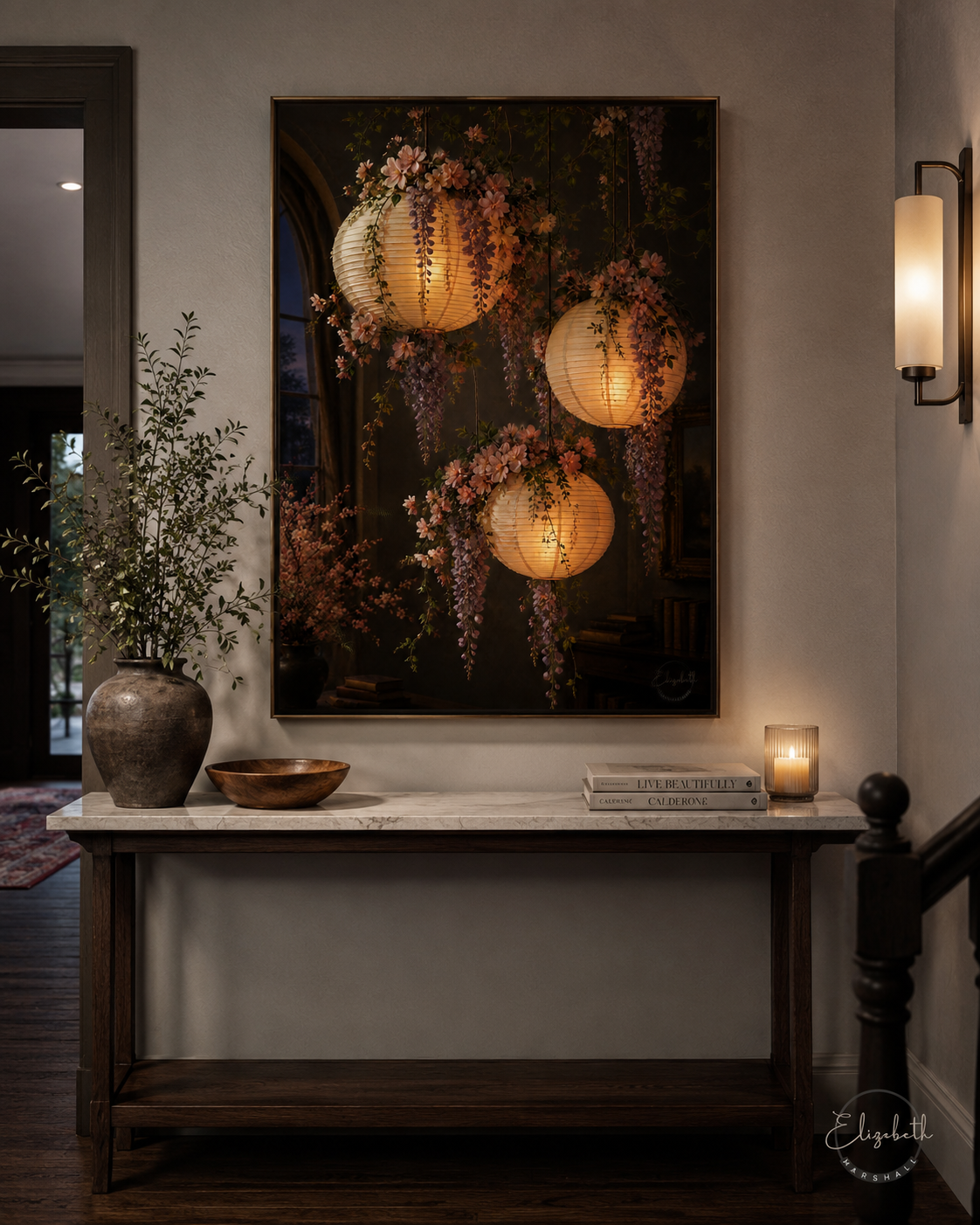 A large vertical wall art print depicting glowing paper lanterns and wisteria flowers against a dark background, displayed above a console table in a styled interior hallway.