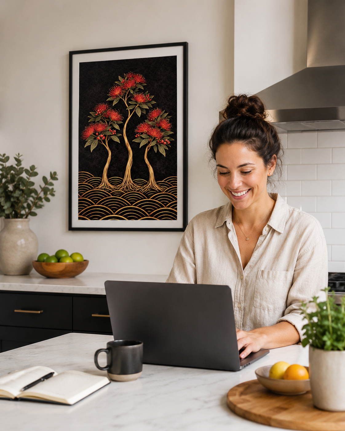 A woman in a beige linen shirt smiles while working on a laptop at a kitchen island, with a framed art print featuring stylized red flowers and gold wave patterns hanging on the wall behind her.
Bold NZ botanical giclee print — deep black, gold & crimson pōhutukawa. Inspired by original designs. 200gsm FSC paper. Ships worldwide.
