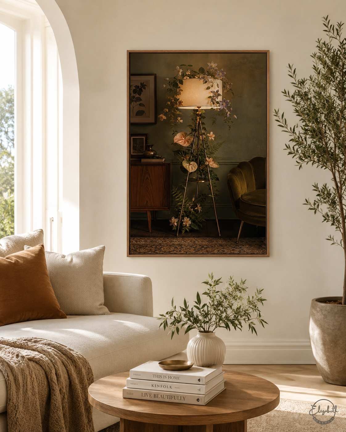 A framed art print depicting a vintage tripod floor lamp with flowers, styled in a warm, modern living room setting with a sofa, wooden coffee table, and potted plant.