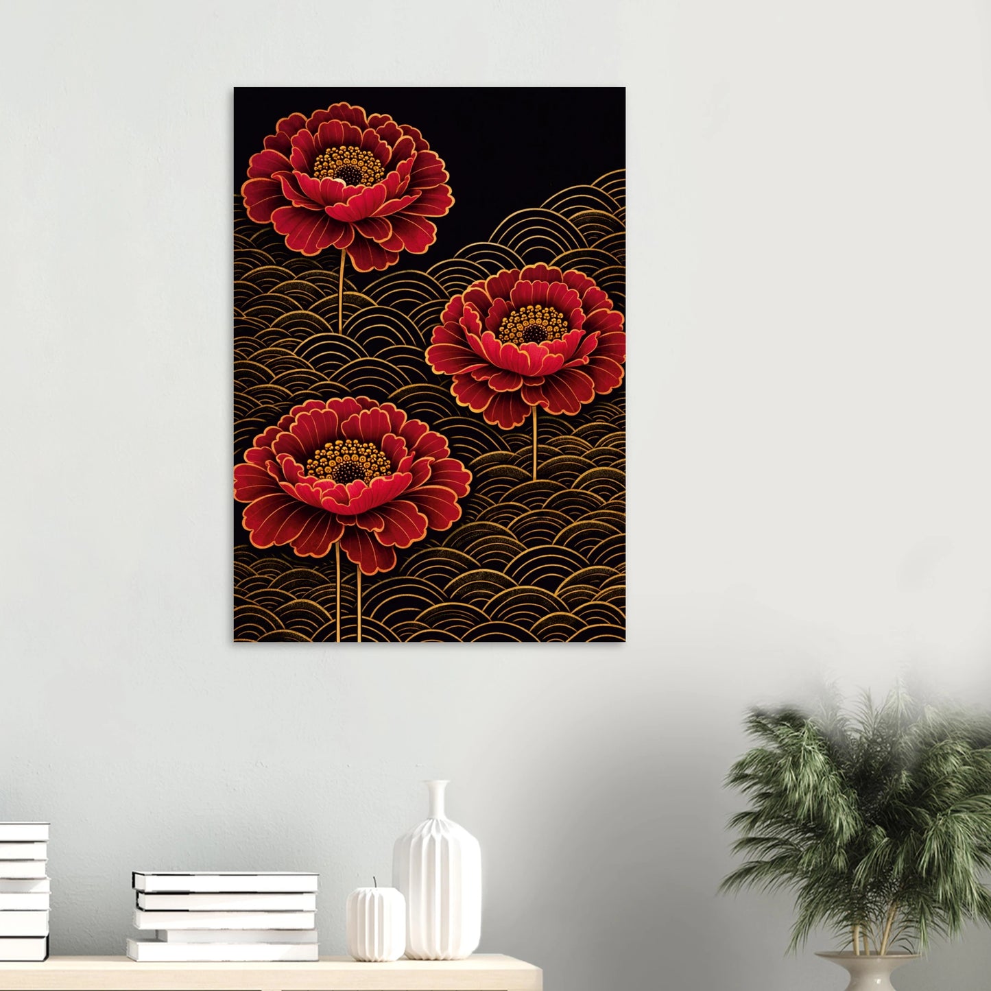 A vertical wall art print featuring three large red peony-like flowers with gold outlines on a black background with gold wave patterns, displayed on a light gray wall above a console table with books, vases, and a plant.
