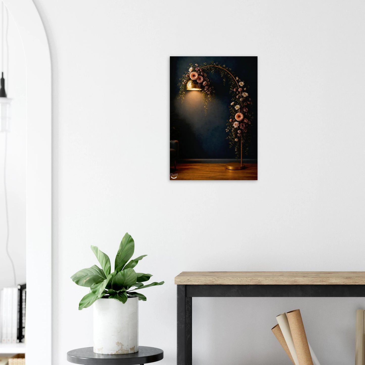 A vertical wall art print depicting a dark floral arch with a warm spotlight, displayed on a white wall above a console table with a potted plant.
