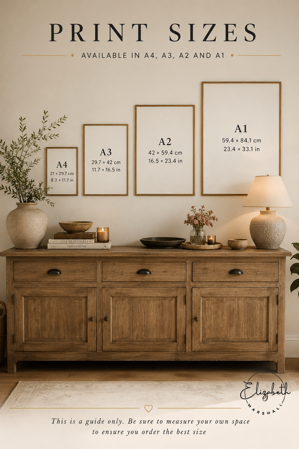 Framed prints of different sizes displayed on a wall above a wooden sideboard.