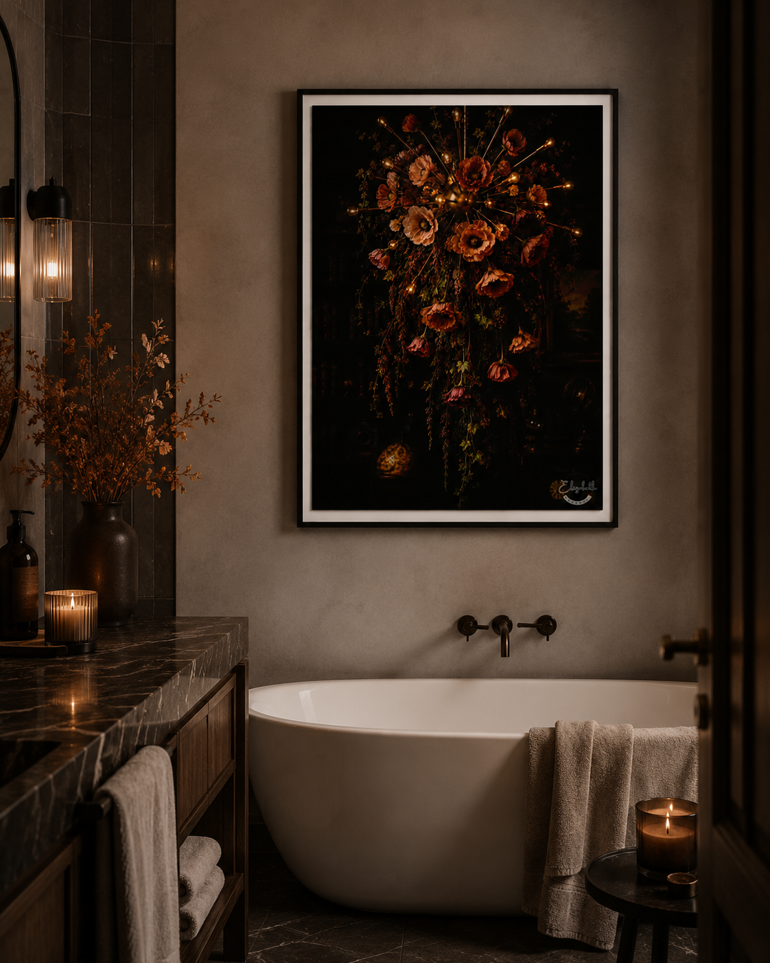 A framed floral wall art print hangs above a freestanding bathtub in a dark, moody bathroom. The artwork shows a dense arrangement of warm-toned flowers on a black background, with the frame and mat visible.