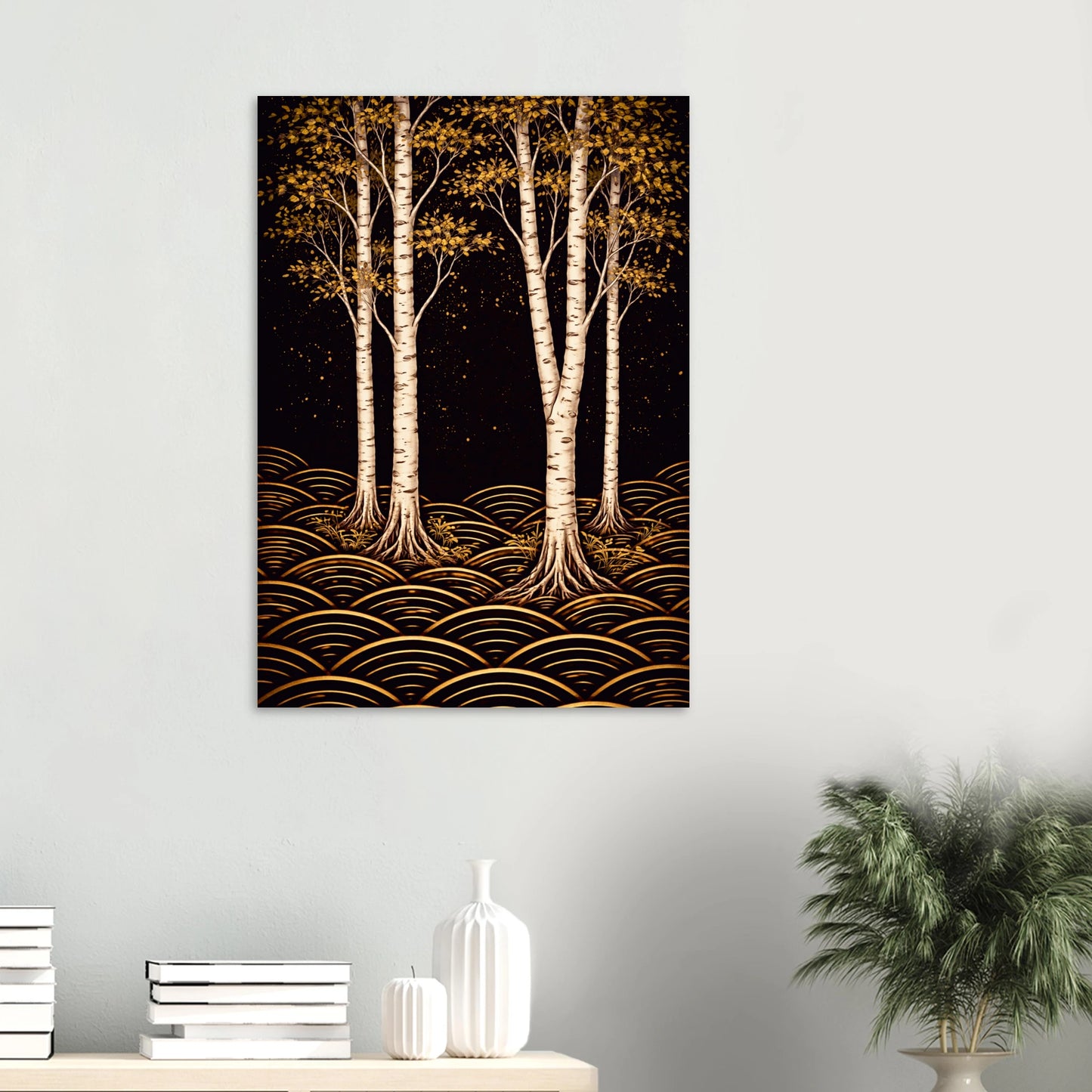 A vertical wall art print depicting stylized white birch trees with golden-yellow foliage and gold wave-like patterns on a black background, displayed on a light gray wall above a console table with books and a plant.