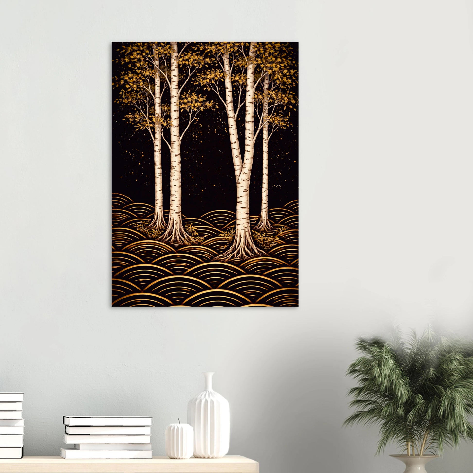 A vertical wall art print depicting stylized white birch trees with golden-yellow foliage and gold wave-like patterns on a black background, displayed on a light gray wall above a console table with books and a plant.