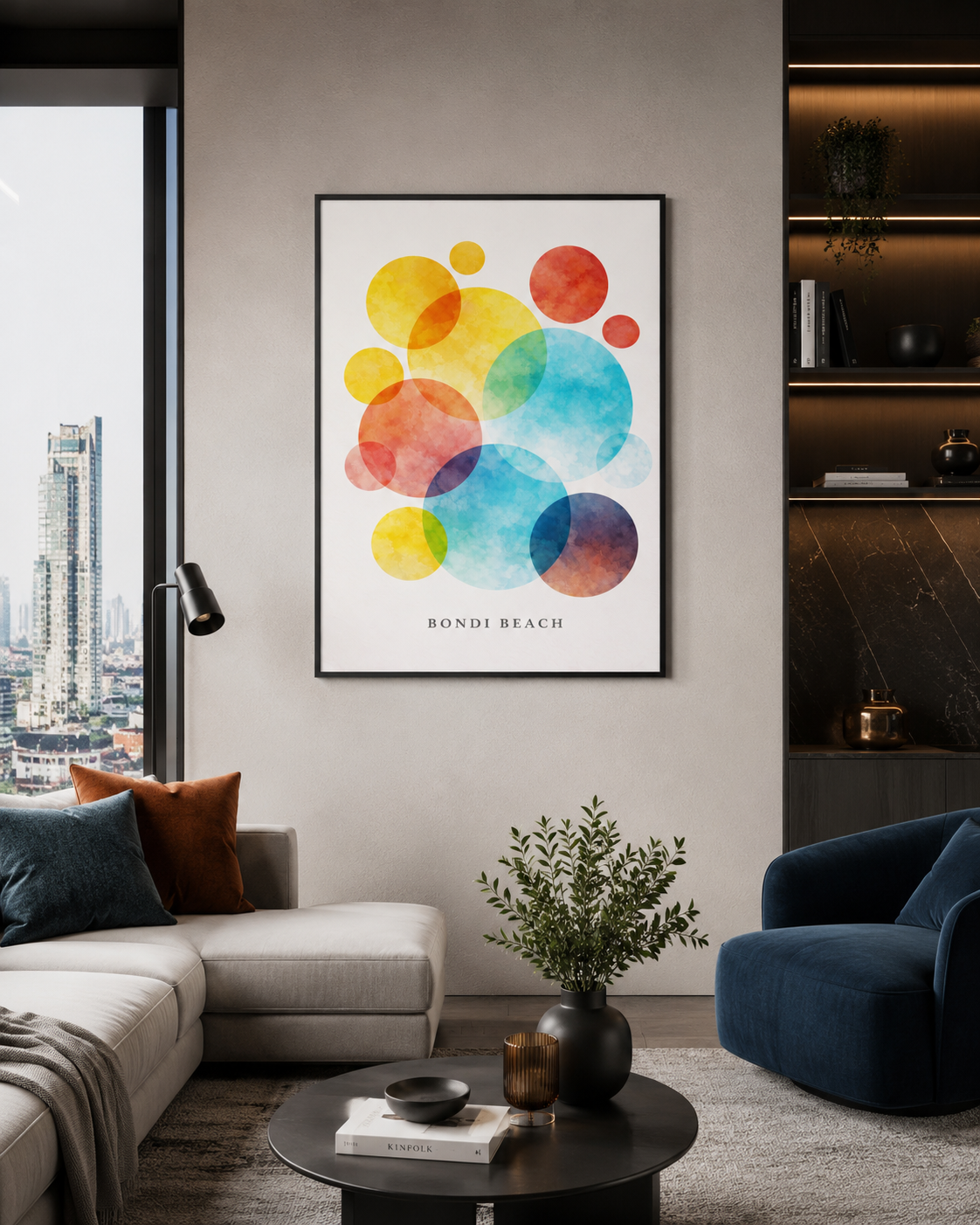 A framed abstract art print featuring colorful overlapping watercolor circles with the text 'BONDI BEACH' at the bottom, displayed on a wall in a modern living room setting.