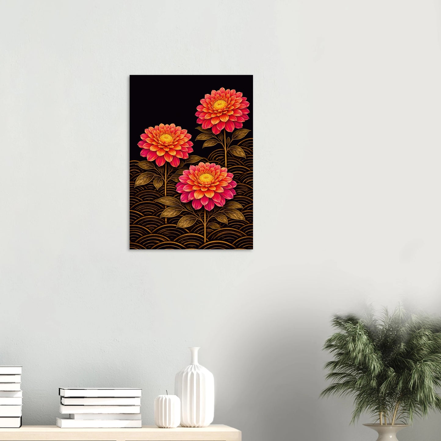 A vertical wall art print featuring three stylized pink and orange flowers with gold wave patterns on a black background, displayed on a light gray wall above a console table with books, vases, and a potted plant.
