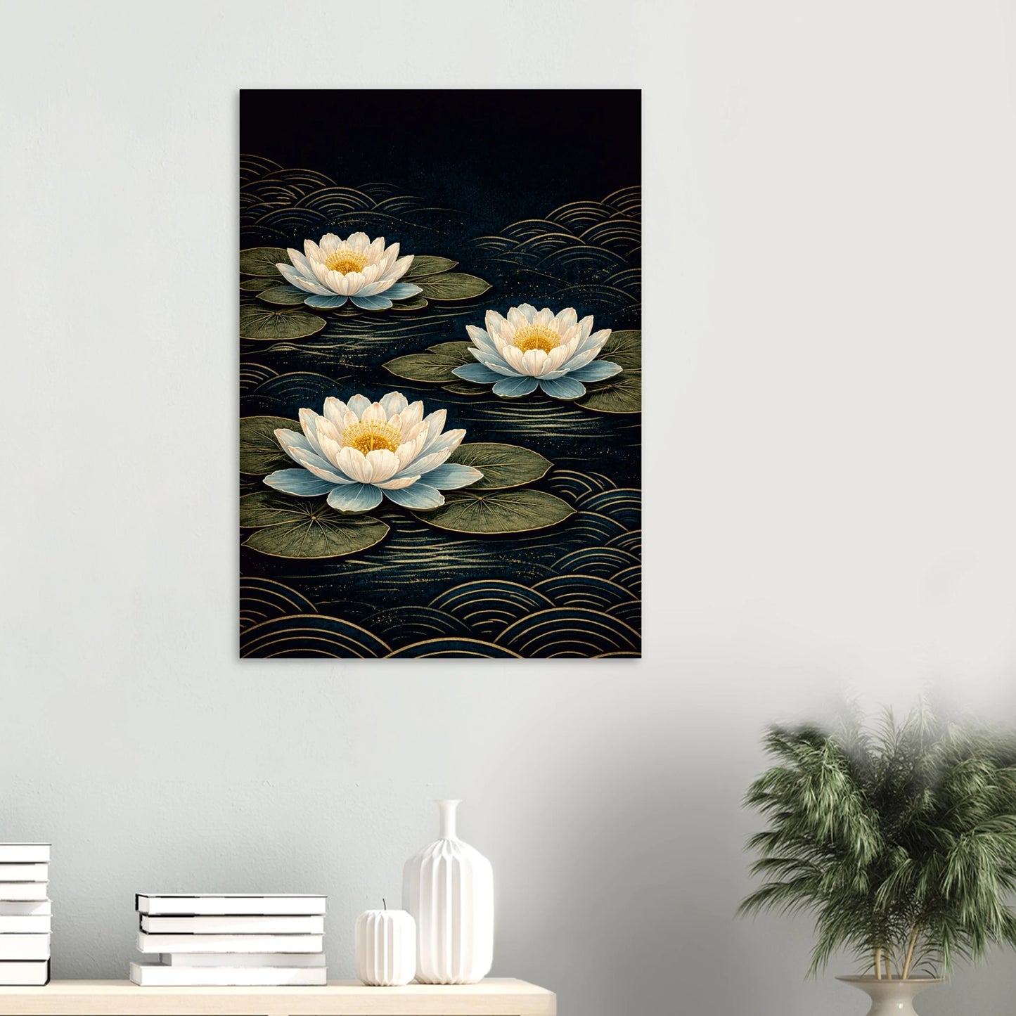 A vertical wall art print depicting three white water lilies on dark water with gold wave patterns, displayed on a light gray wall above a console table with books and a plant.
