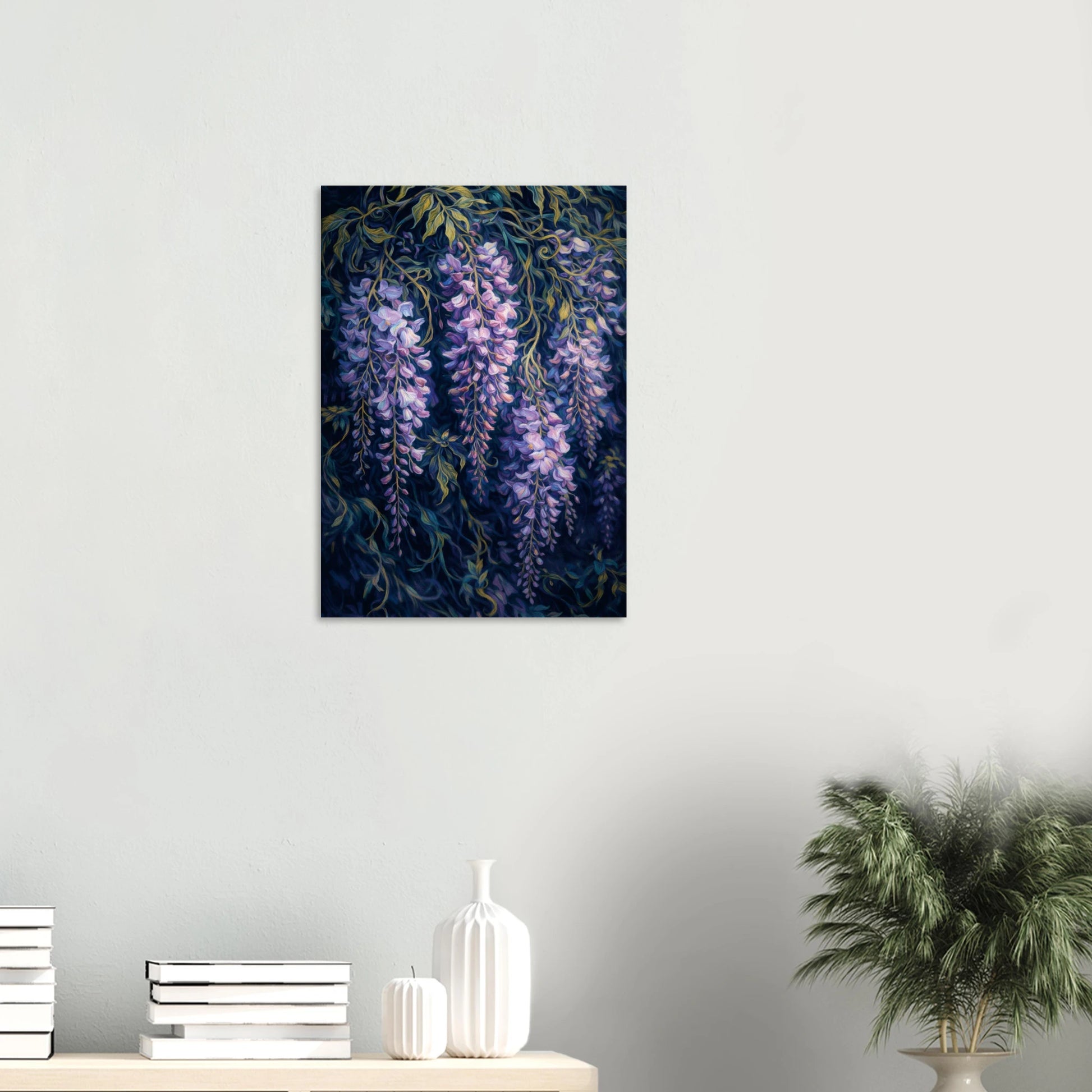 A vertical canvas wall art print depicting purple wisteria flowers hanging from dark blue-black vines, displayed on a light gray wall above a styled shelf with books, white vases, and a potted plant.