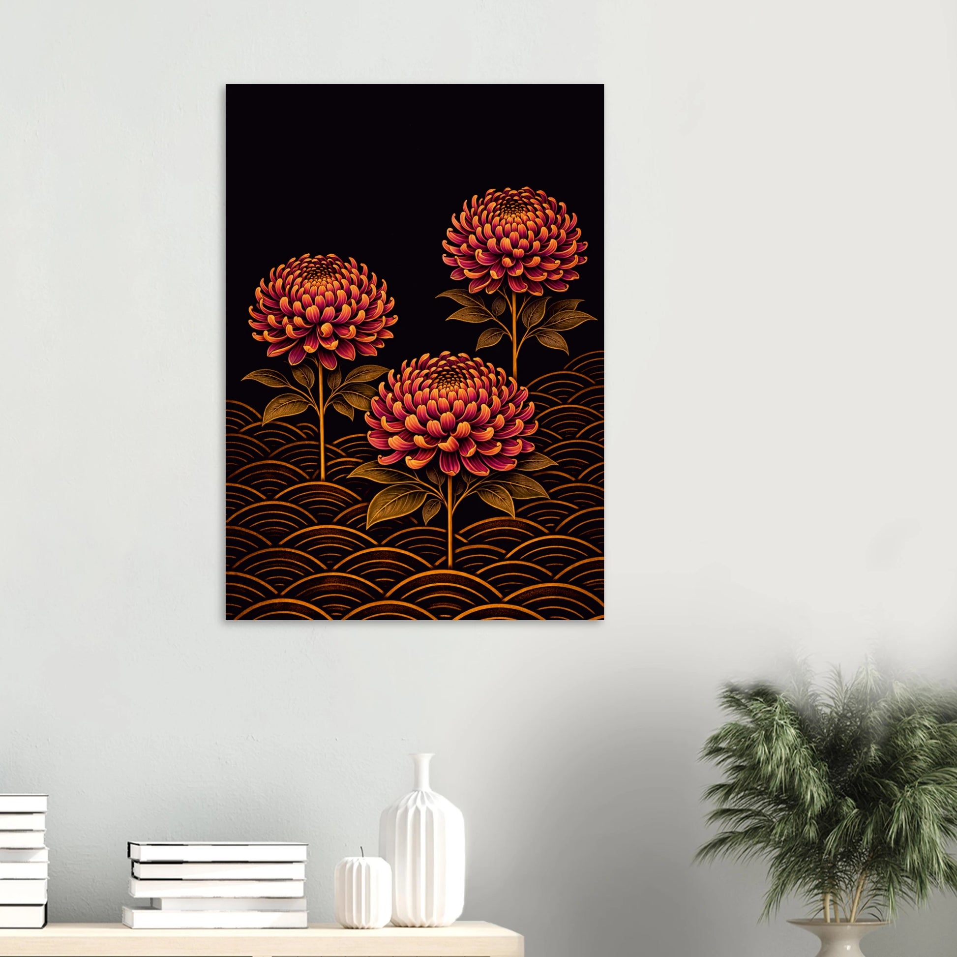 A vertical wall art print featuring three stylized red-orange flowers with gold wave patterns on a black background, displayed on a light gray wall above a console table with books and a plant.