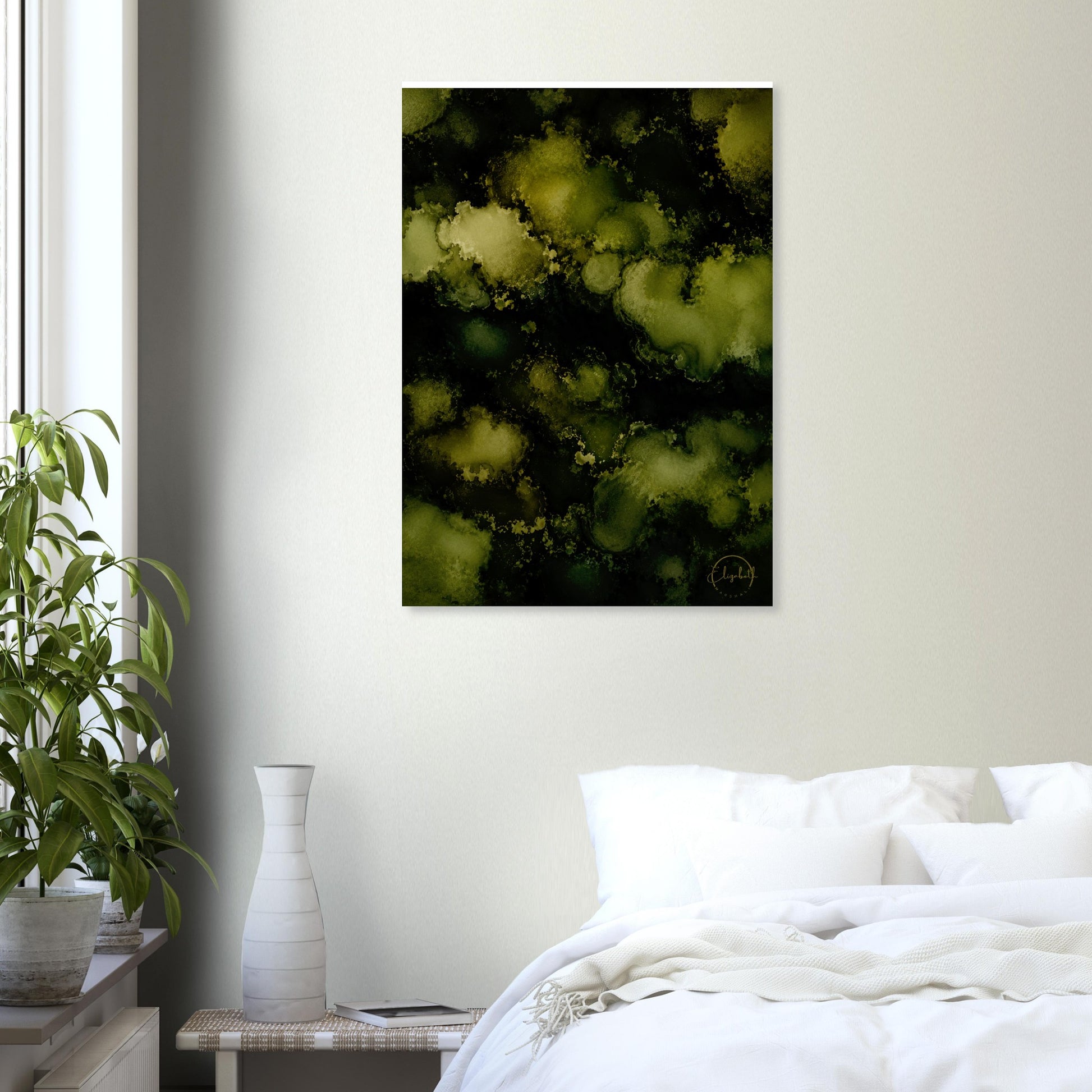 A vertical abstract wall art print featuring a dark green and black background with glowing olive-yellow bokeh-like circles, displayed in a bedroom setting above a bed with white bedding and next to a potted plant.