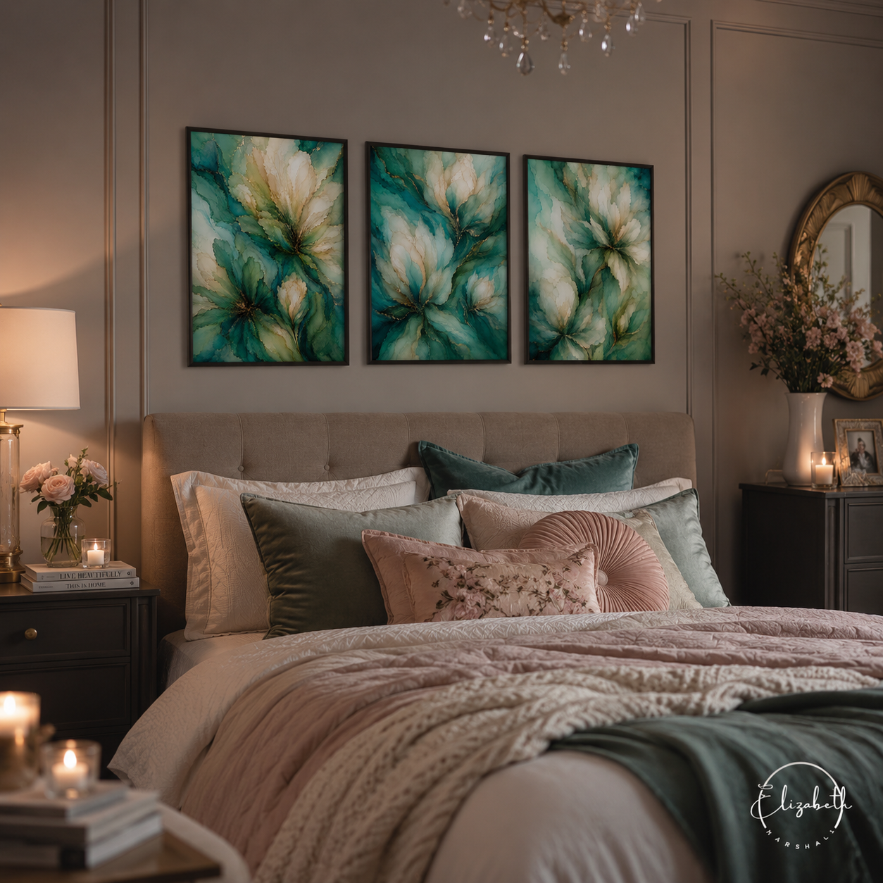 A styled bedroom scene with a bed dressed in blush pink, cream, and sage green bedding, beneath three matching framed abstract floral wall art prints in teal, cream, and olive tones. The room has warm ambient lighting, nightstands, candles, and a chandelier.