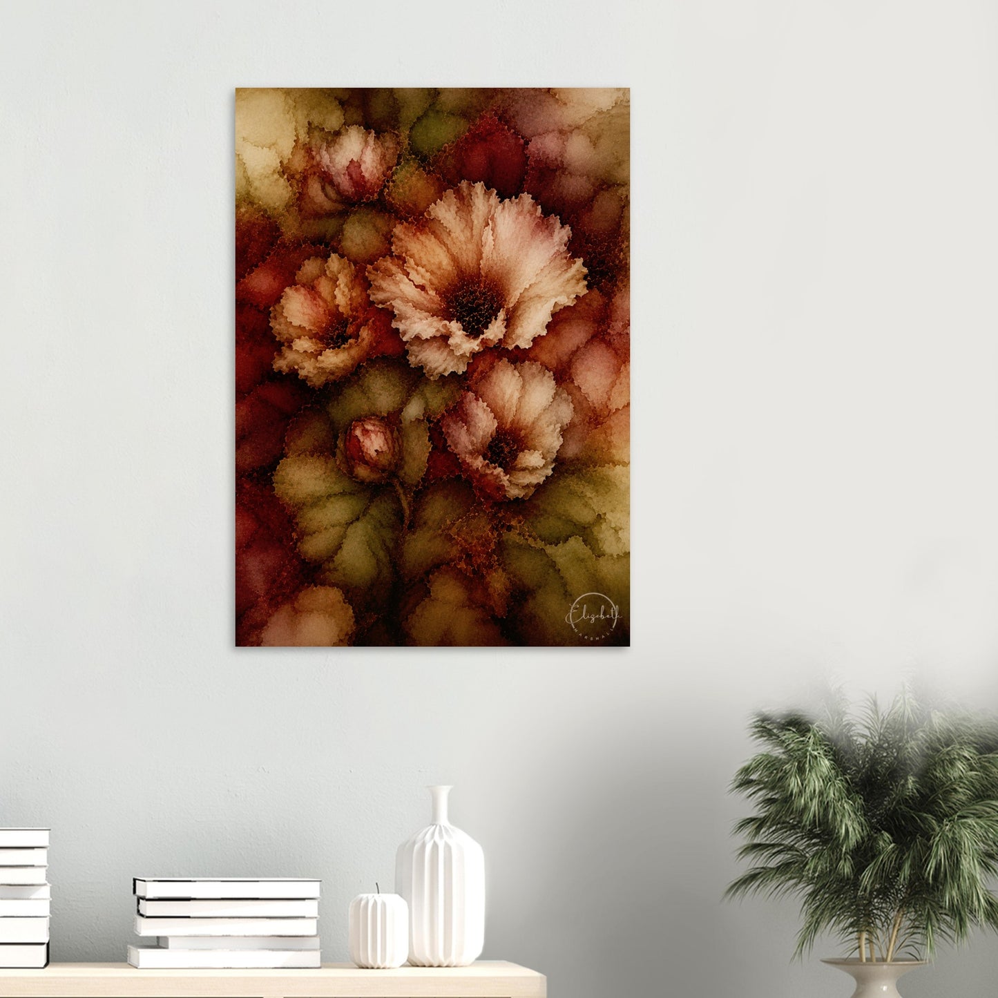 A vertical canvas wall art print featuring abstract watercolor-style flowers in warm earthy tones, displayed on a light gray wall above a console table with books, white vases, and a potted plant.