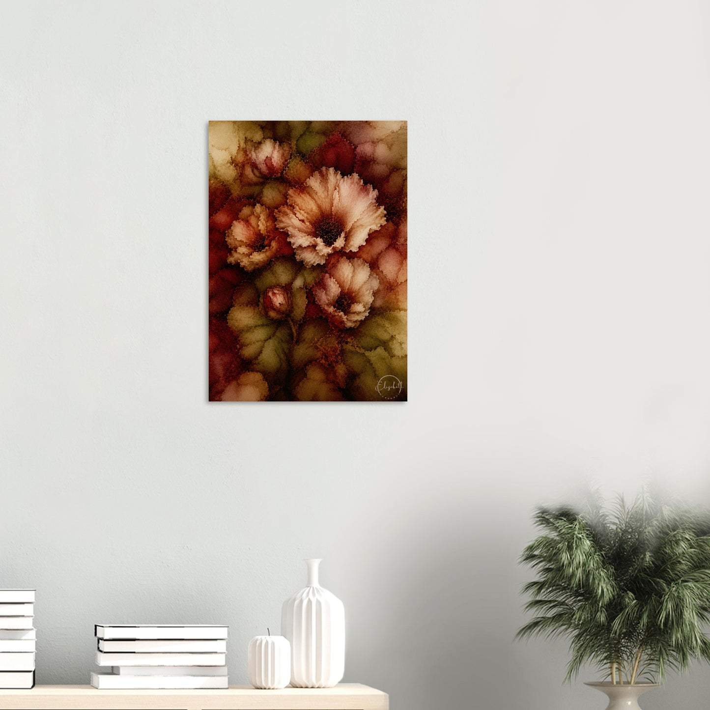 A vertical canvas wall art print featuring an abstract floral design in warm autumn tones, displayed on a light gray wall above a wooden shelf with books, white vases, and a potted plant.