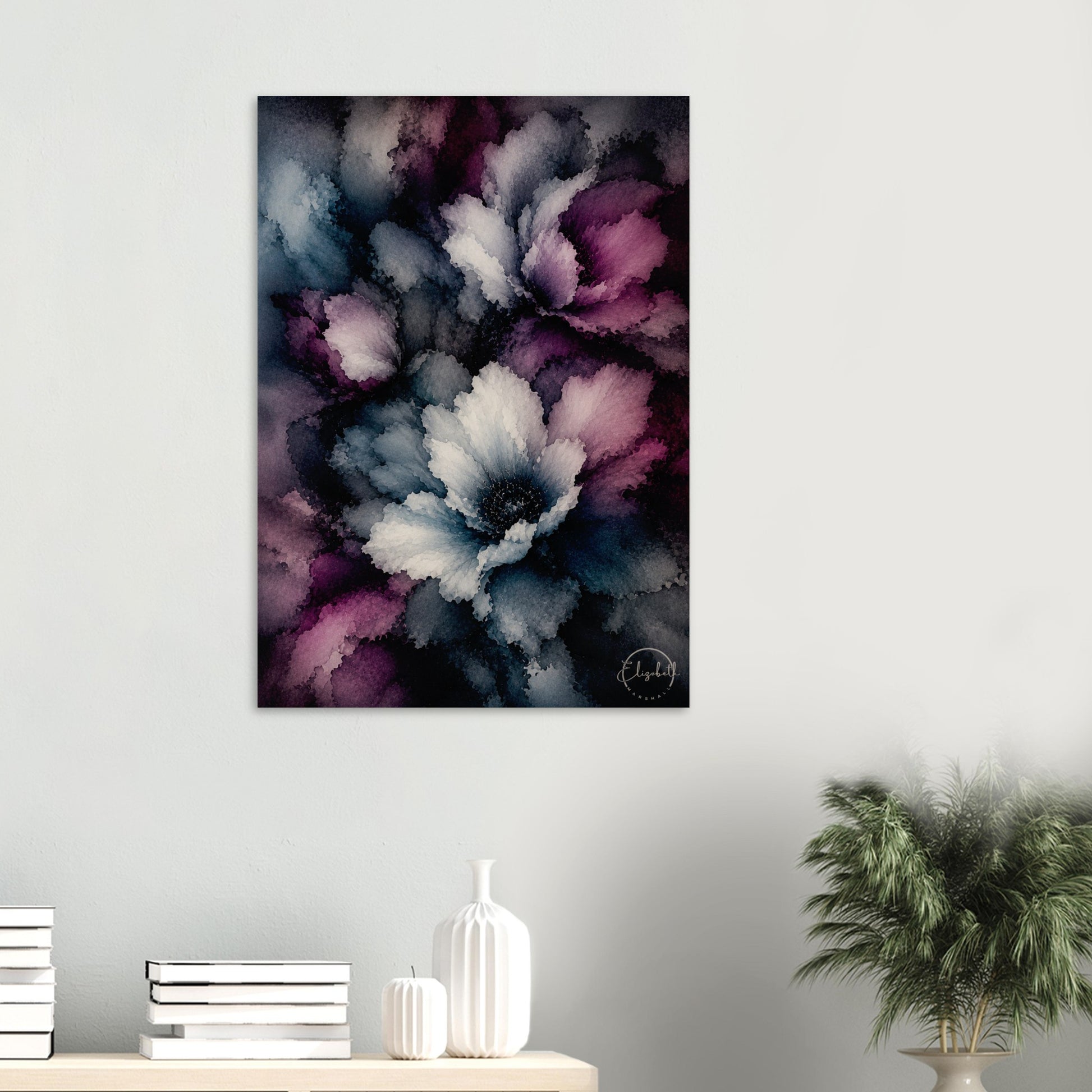 A vertical canvas wall art print featuring an abstract floral design in shades of purple, blue, black, and white, displayed on a light gray wall above a console table with books and a plant.