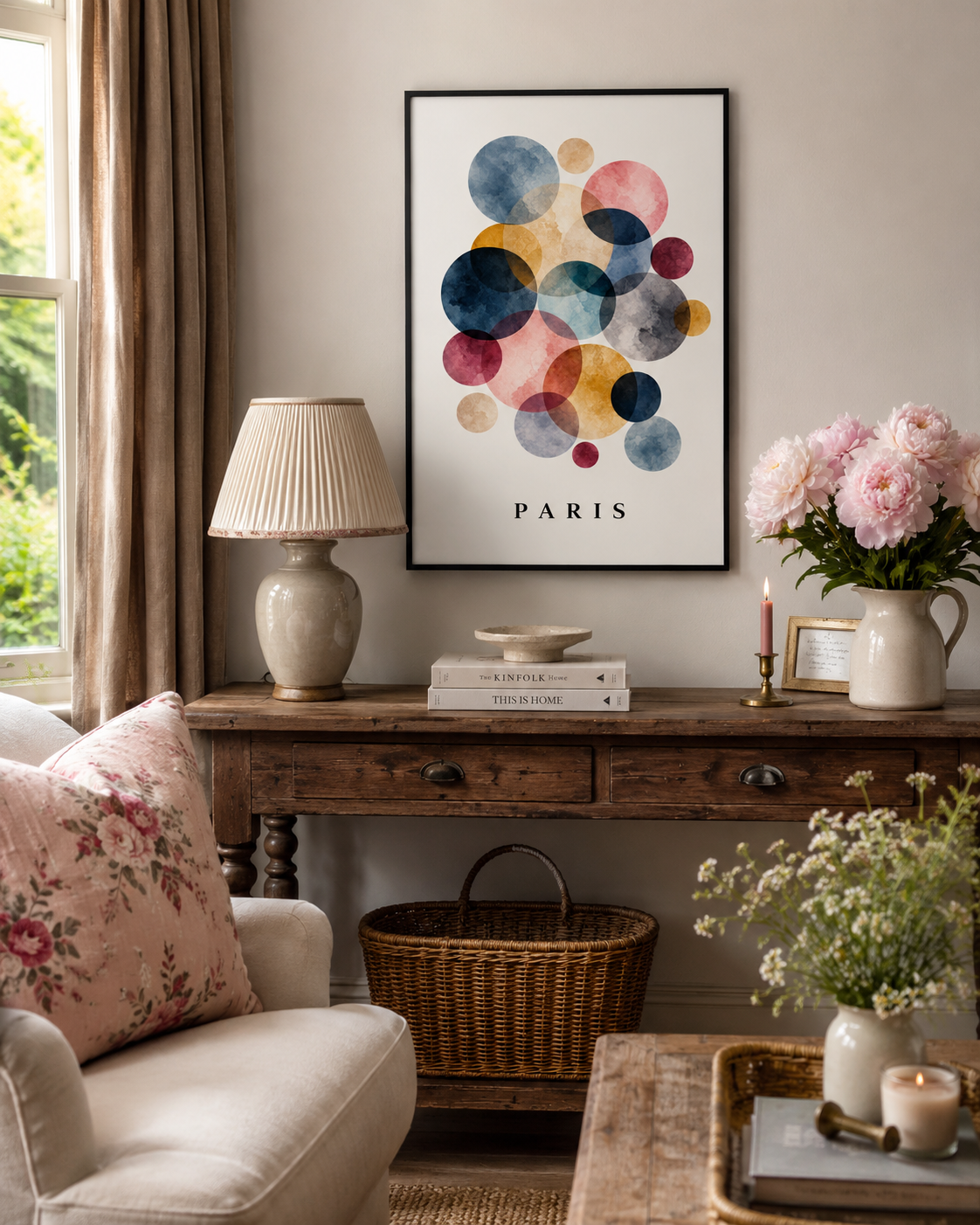A framed abstract art print featuring colorful watercolor circles with the word 'PARIS' at the bottom, displayed on a wall above a rustic wooden console table in a styled living room setting.