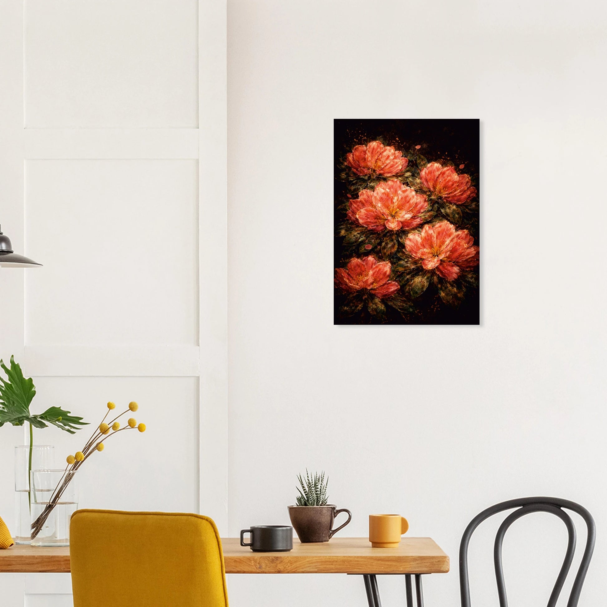 A vertical canvas wall art print featuring a cluster of vibrant orange-red peonies on a dark background, displayed on a white wall in a modern dining room setting.