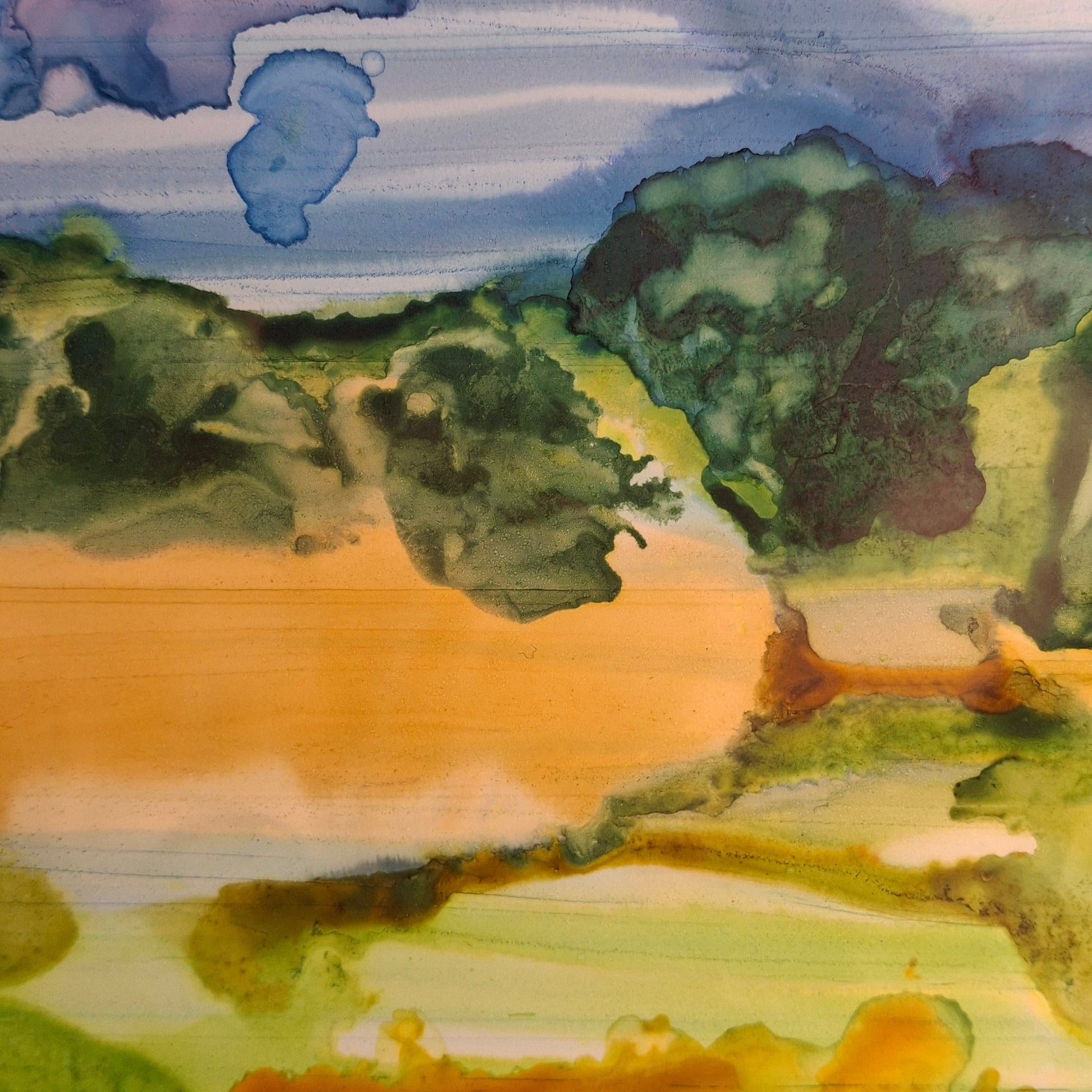 landscape painting featuring green hills, a winding golden-orange river, and a dramatic blue and purple sky.
