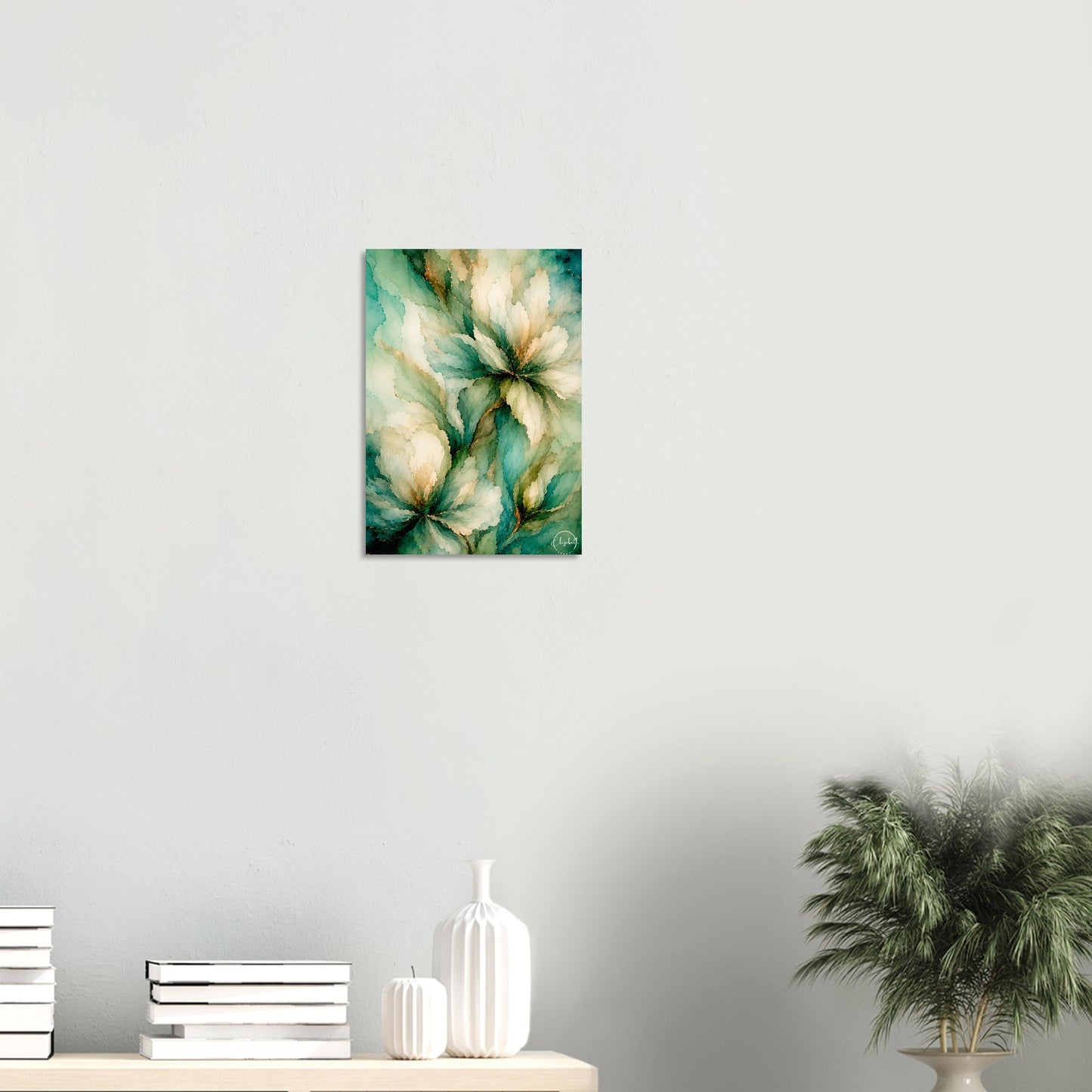 A vertical wall art print featuring an abstract painting of green and cream flowers, displayed on a light gray wall above a console table with books, vases, and a potted plant.