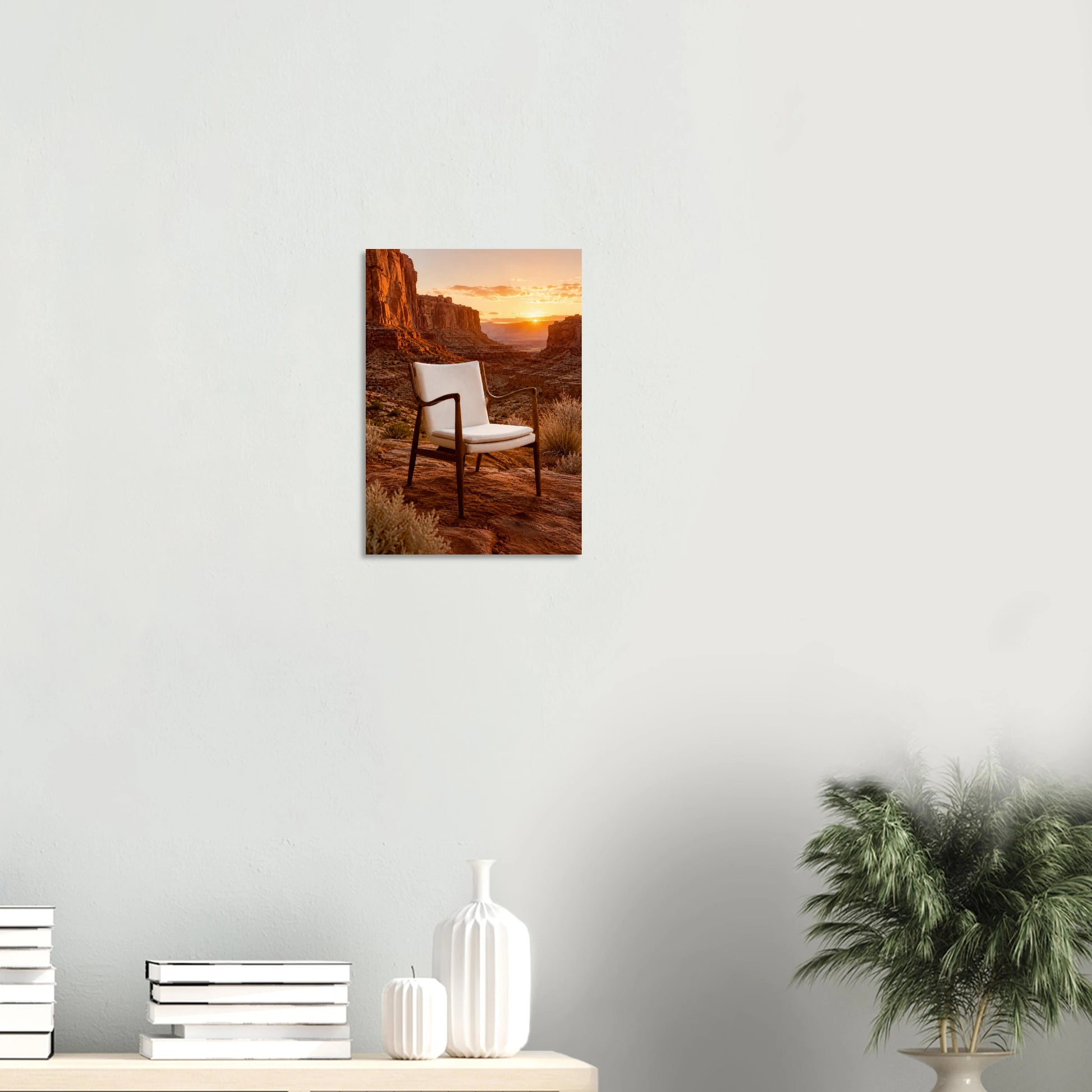 The Chair Chased the Sunset and made it all the way to the canyon. A Finn Juhl 45 Chair-inspired piece, its sculpted dark wooden frame and cream upholstered seat perfectly composed, sits alone in a vast red canyon landscape as the sun burns low between the mesa walls. Everything is amber and terracotta and the particular kind of quiet that only exists at golden hour in a place this big. The chair looks completely at ease. It has been here before.