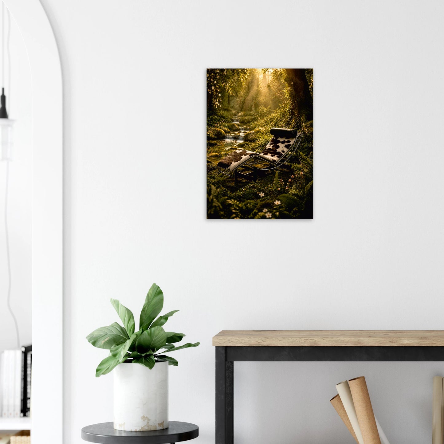A vertical canvas wall art print depicting a sunlit forest scene with a retro chaise lounge, displayed on a white wall above a console table with a potted plant.