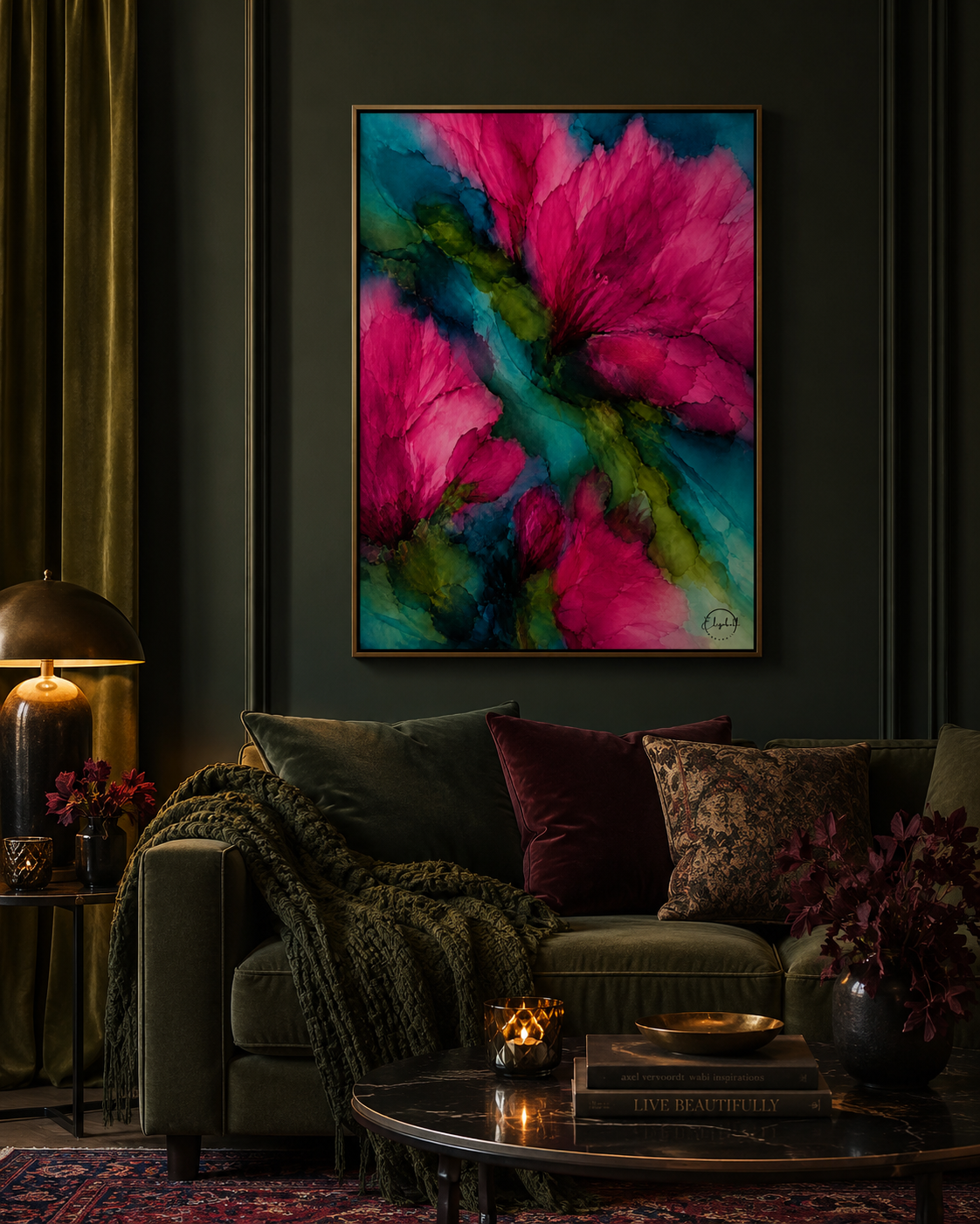 A framed abstract floral painting with vibrant pink and teal brushstrokes hangs on a dark green wall above a styled sofa in a moody living room setting.