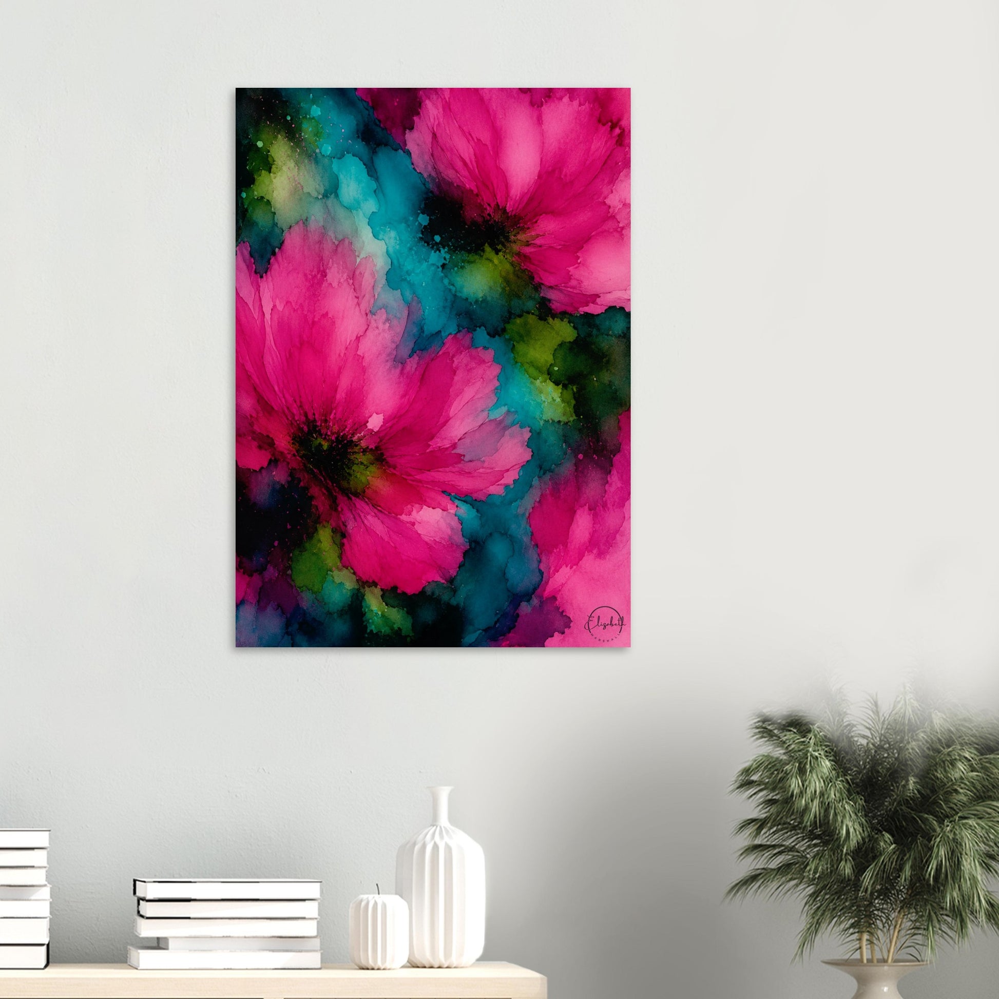 A vertical canvas wall art print featuring vibrant pink watercolor flowers with teal and green watercolor backgrounds, displayed on a light gray wall above a console table with books and a potted plant.