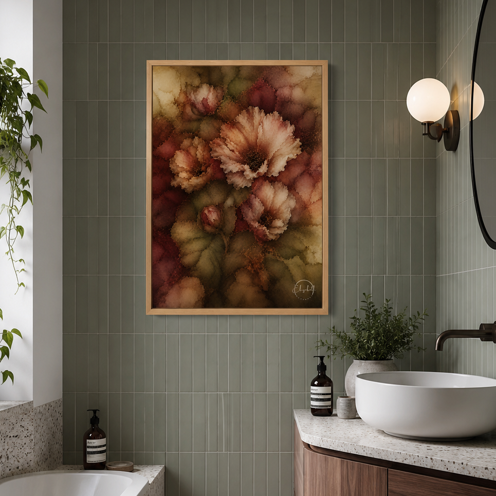 A framed floral wall art print hangs on a green tiled bathroom wall above a white vessel sink and wooden vanity. A bathtub, plants, wall sconces, and a round mirror are visible in the styled interior.

Wild Passion blooms in the half-light, blush and cream petals unfurling against depths of olive green and burgundy, the colours layered and luminous in the way that only alcohol ink can achieve. The blooms are full and unhurried, their edges soft, their centres dark and warm, the whole composition radiating t
